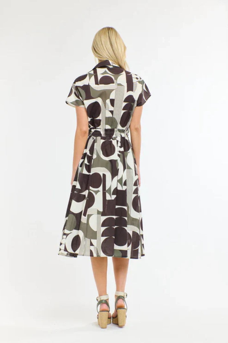Woman wearing a patterned dress on a white background