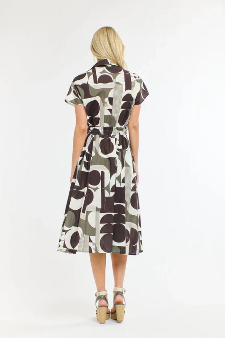 Woman wearing a patterned dress on a white background