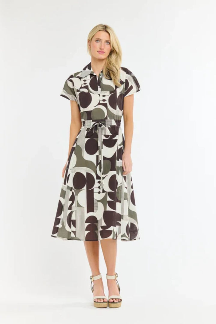 Woman wearing a patterned dress on a white background