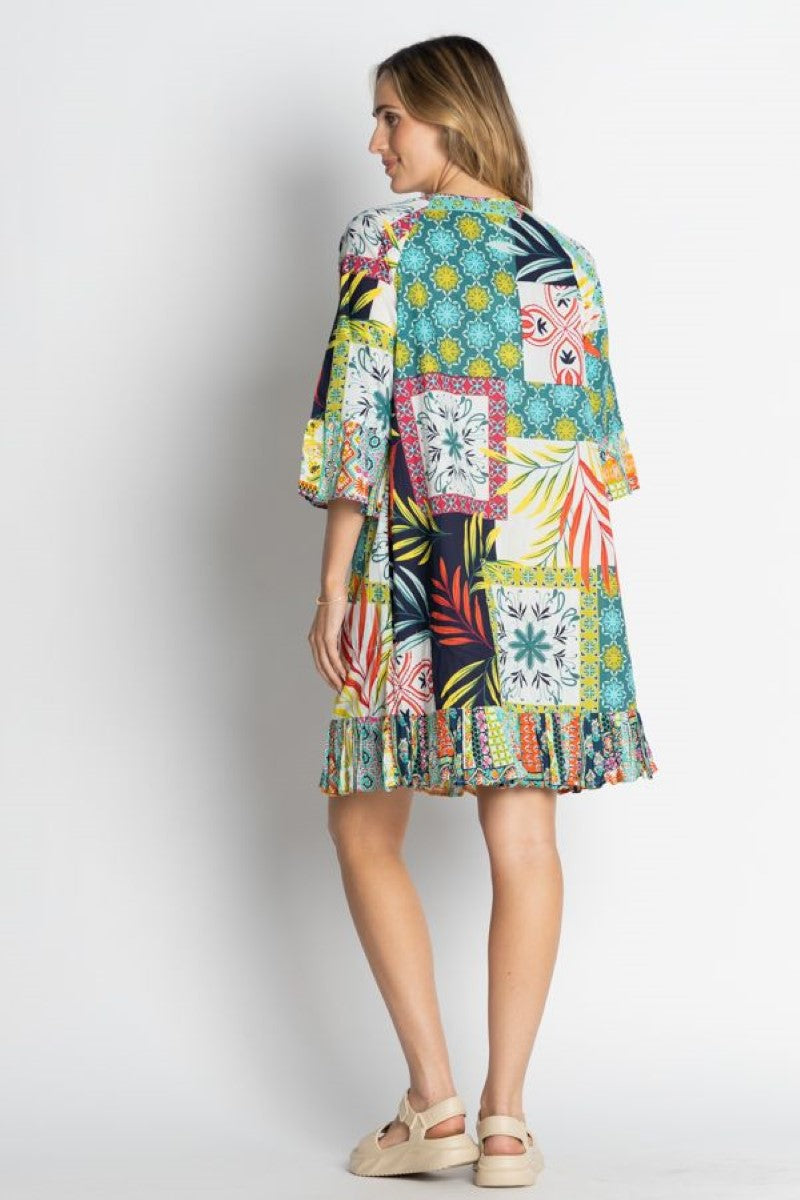 Woman wearing a colorful patterned dress on a white background