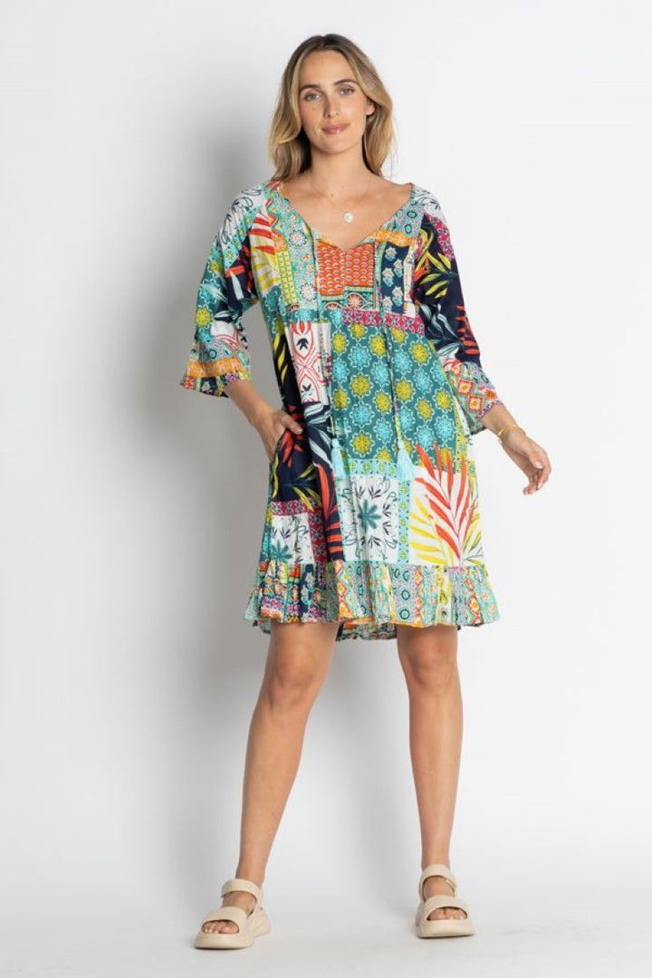 Woman wearing a colorful patterned dress on a white background