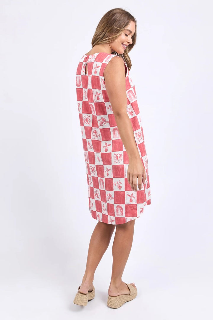 Woman wearing a red and white checkered dress on a white background