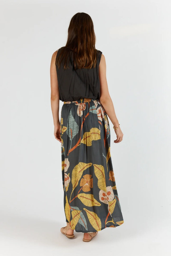 Woman wearing a floral skirt with a plain background