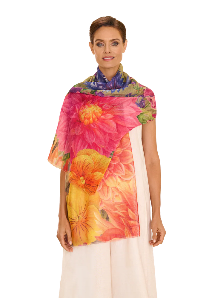 Woman wearing a colorful floral scarf on a white background