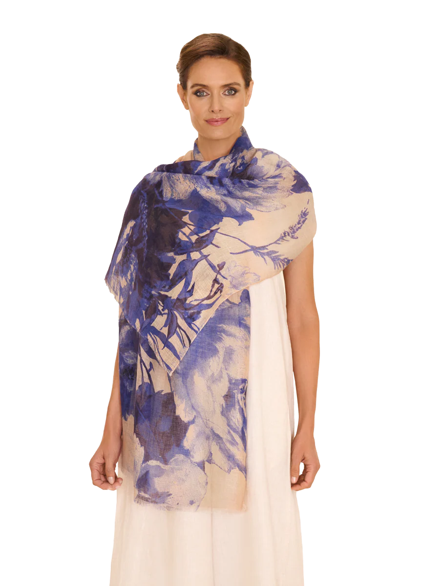 Woman wearing a blue and white patterned scarf on a white background