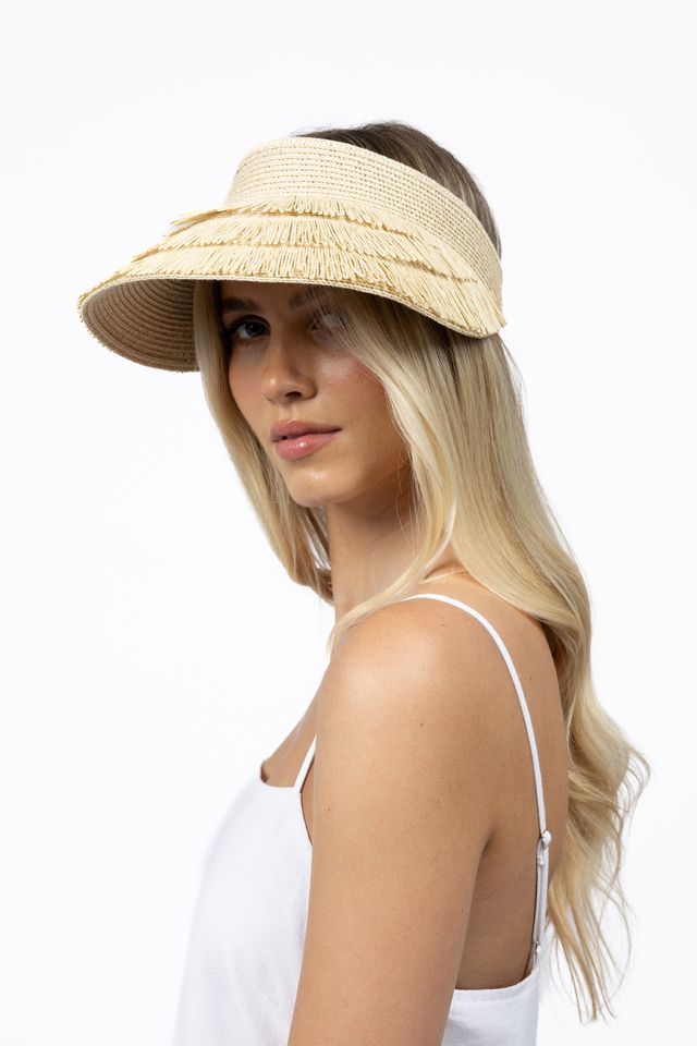 Woman wearing a straw visor on a white background