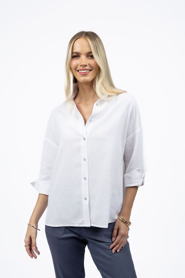 Woman wearing a white blouse and blue pants on a white background