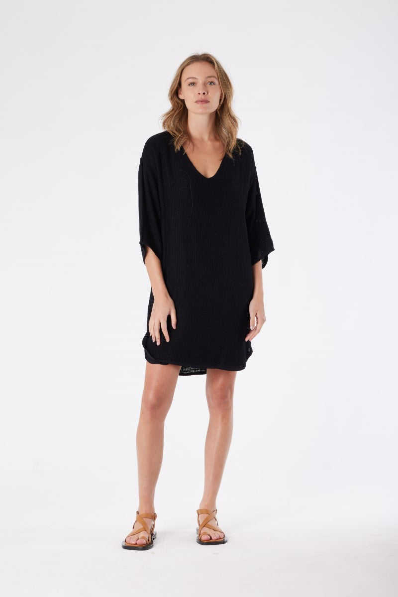 Step out in style with the Carbon Estelle Hessian Dress in Black at Ivy Vibe—v-neck, fully lined, 3/4 sleeves, side splits, and scooped hem for effortless edge.