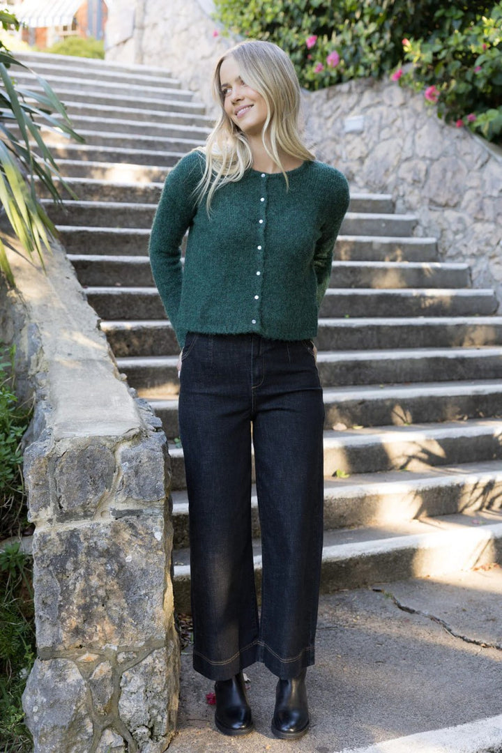 Lifestyle image of the Fleetwood Jean in black, featured at Ivy Vibe Boutique, highlighting its sleek fit and timeless denim style in a relaxed setting.