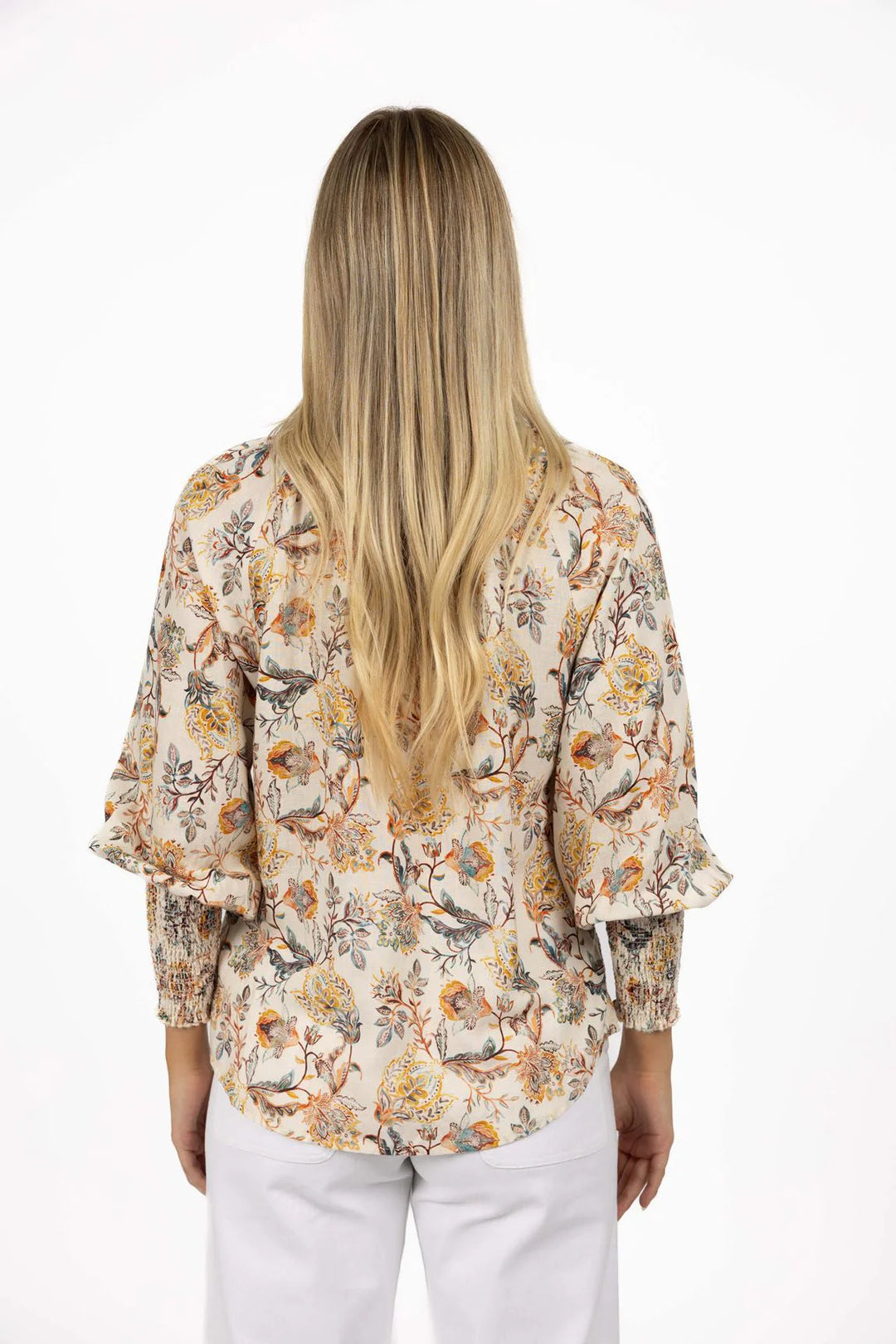 Woman wearing a floral blouse with a white background