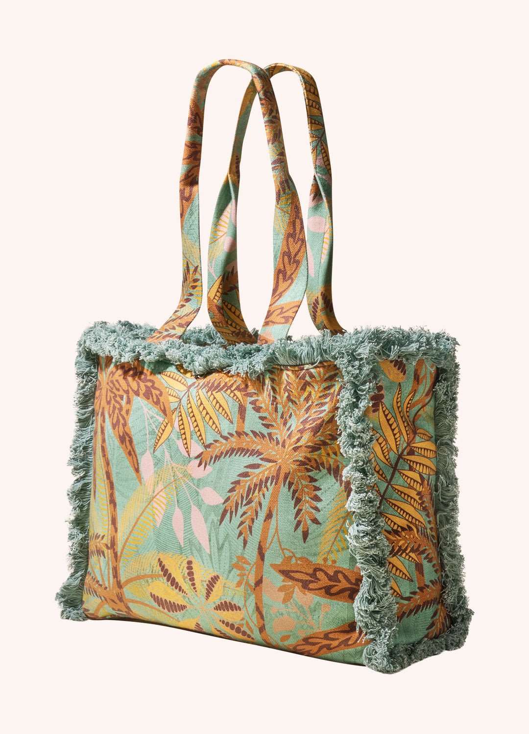 Tropical patterned tote bag with frayed edges on a white background