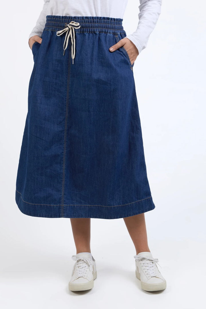 Close-up of Greta Denim Skirt in dark blue, showcasing the rich denim texture, front seam, and waistband stitching, from Ivy Vibe Boutique.