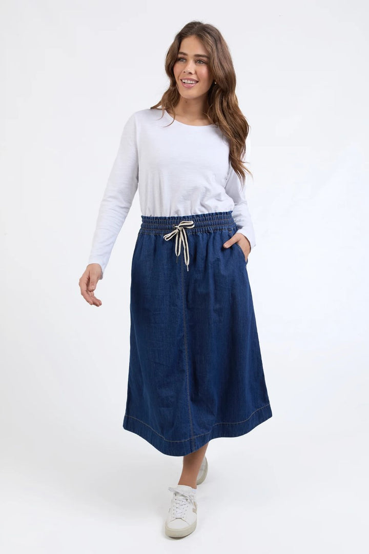 Front view of Greta Denim Skirt in dark blue, showcasing a high-waisted design with front seam detailing, from Ivy Vibe Boutique.