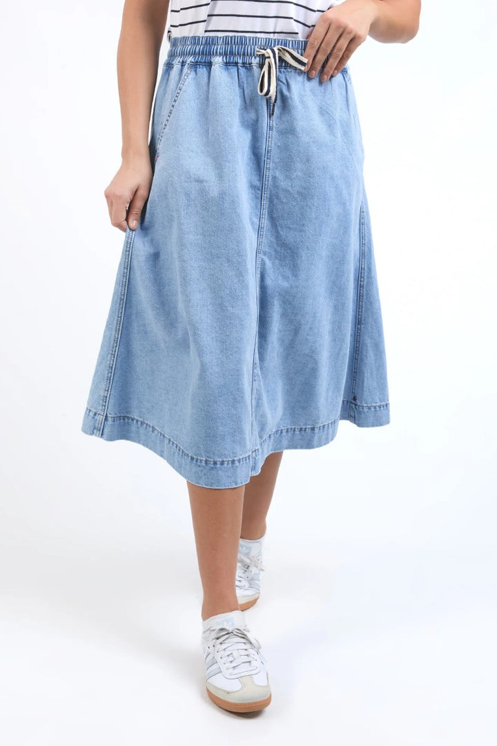 Close-up of Greta Denim Skirt in light blue, highlighting the denim texture, front seam, and waistband detail, from Ivy Vibe Boutique.