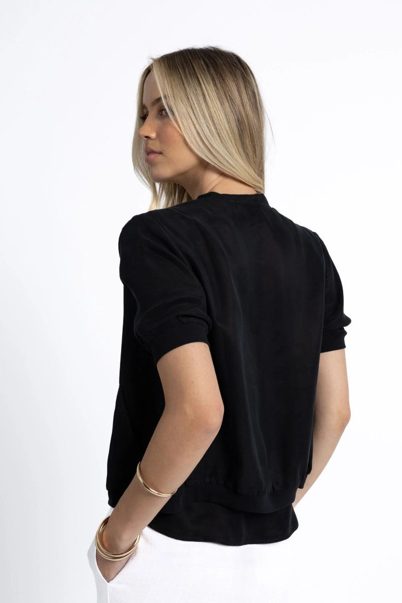 Woman wearing a black top on a white background
