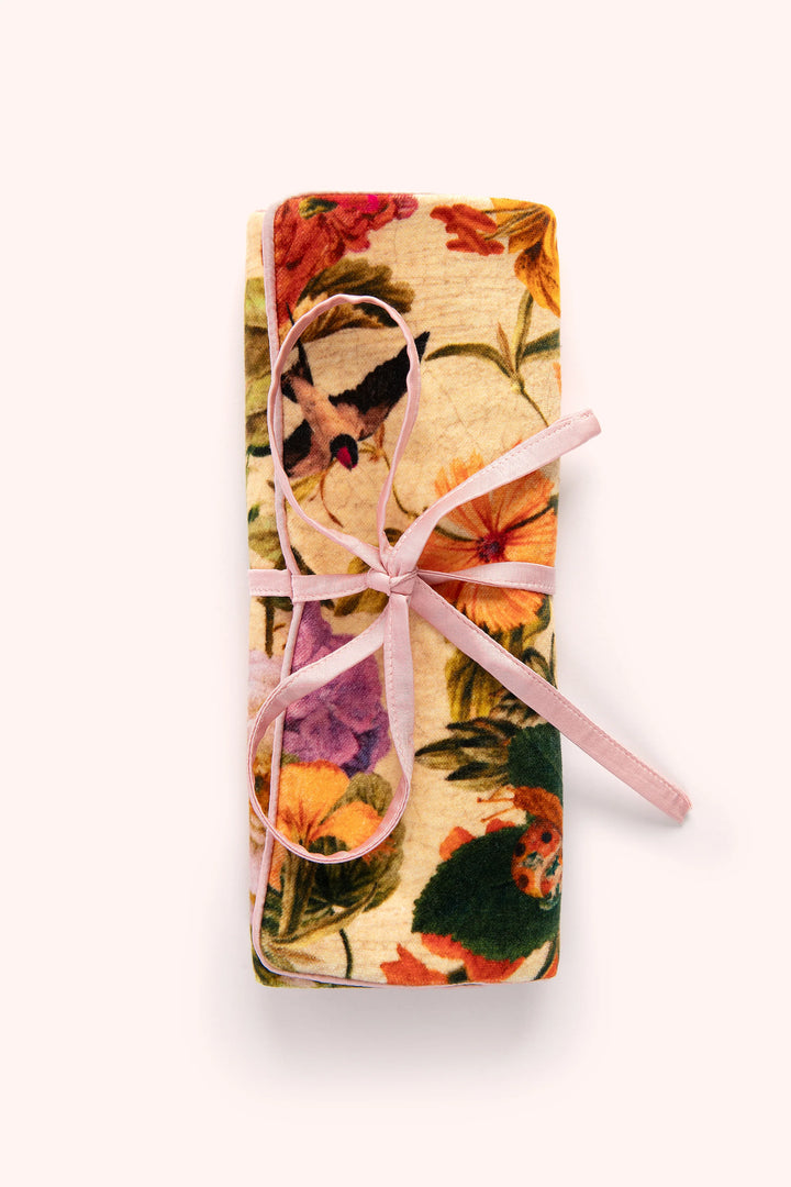 Floral-patterned product with a pink ribbon on a white background