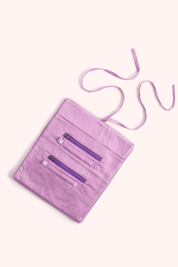 Purple crossbody bag with a strap on a white background