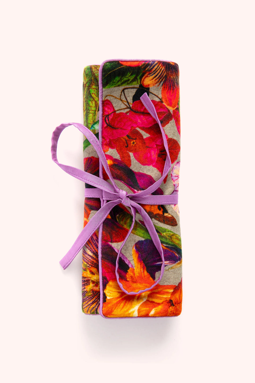 Colorful floral-patterned gift box with a purple ribbon on a white background