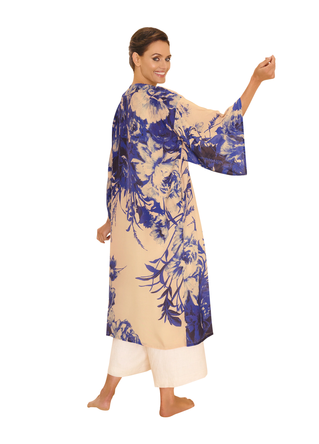 Woman wearing a blue and beige floral dress on a white background