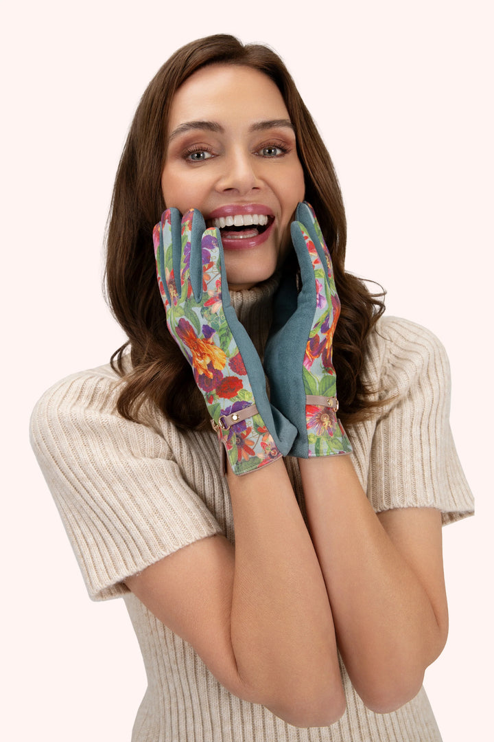 Woman wearing colorful floral gloves on a white background
