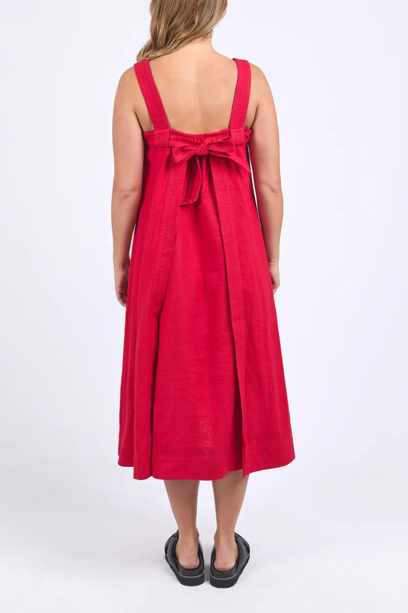 Red dress with a bow detail on the back worn by a person on a white background