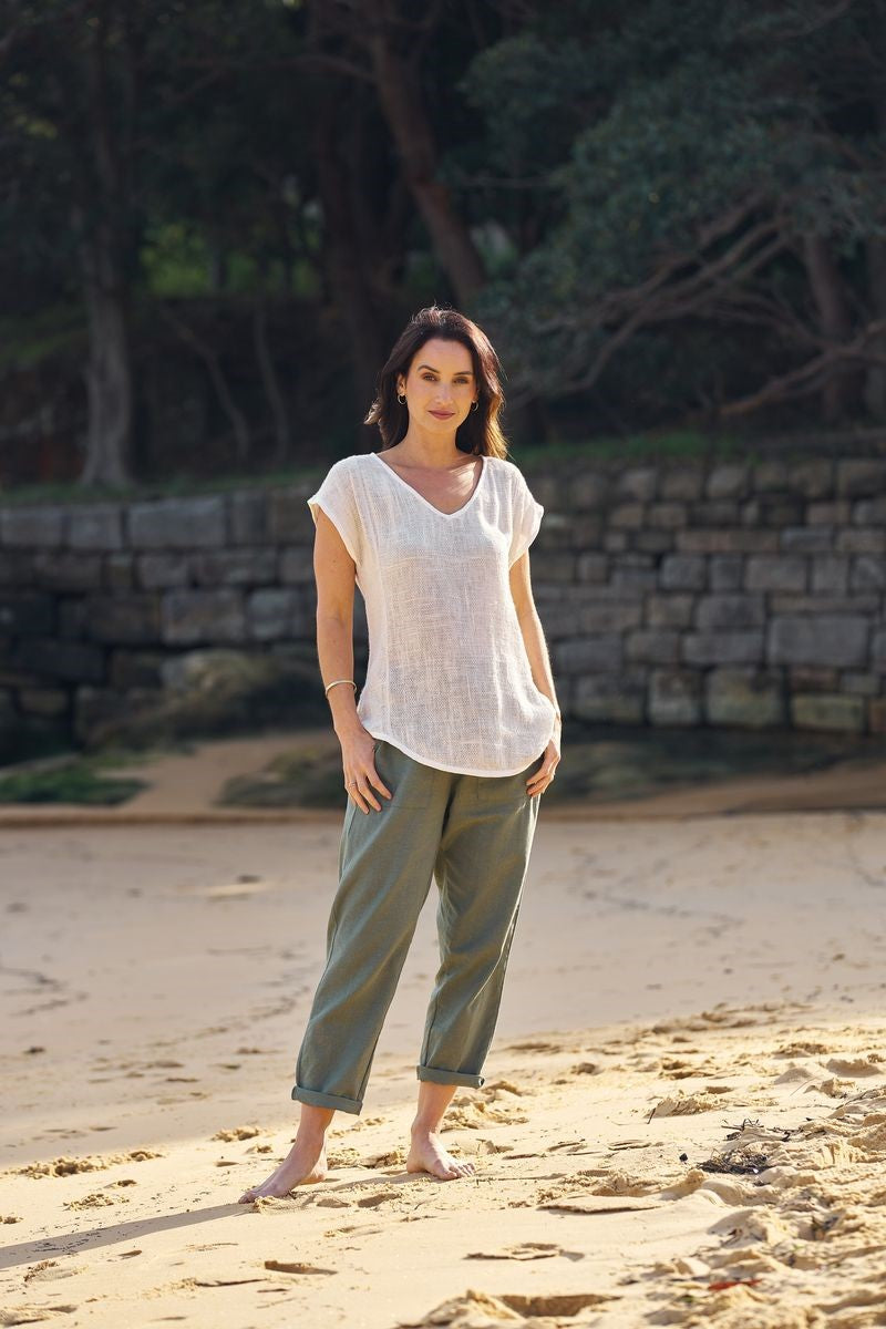 Lifestyle image of the Lyra Hessian Tunic in white, showcased at Ivy Vibe, featuring a relaxed fit, V-neckline, and lightweight handwoven cotton fabric in a casual setting.