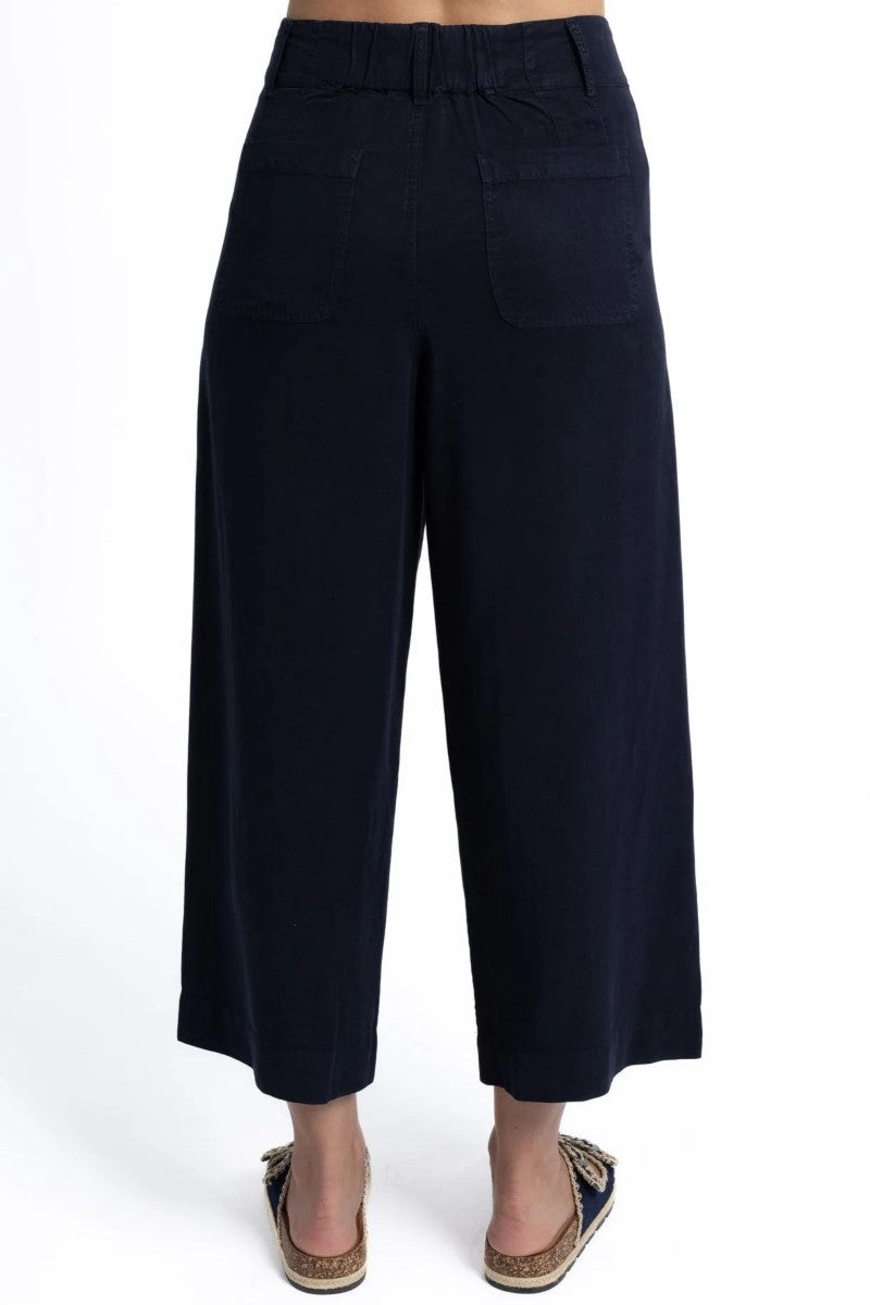 Black wide-leg pants worn by a person on a white background