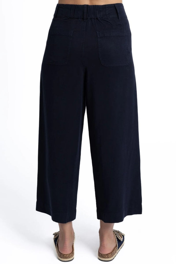 Black wide-leg pants worn by a person on a white background