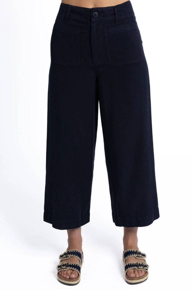 Black wide-leg pants worn by a person on a white background