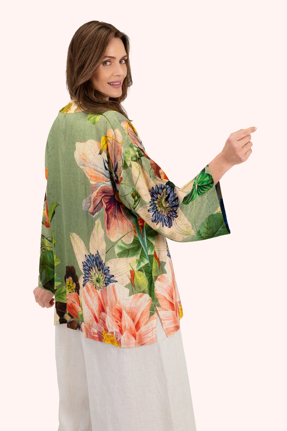 Woman wearing a floral kimono-style garment on a white background