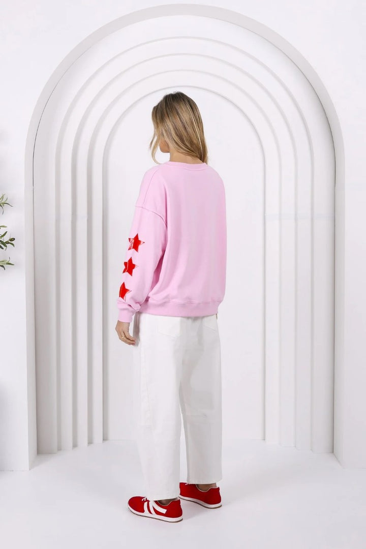 Back view of the MJ Sweat in Pink from Ivy Vibe, showcasing the relaxed fit, long sleeves, and smooth textured fabric for a cozy, laid-back look.