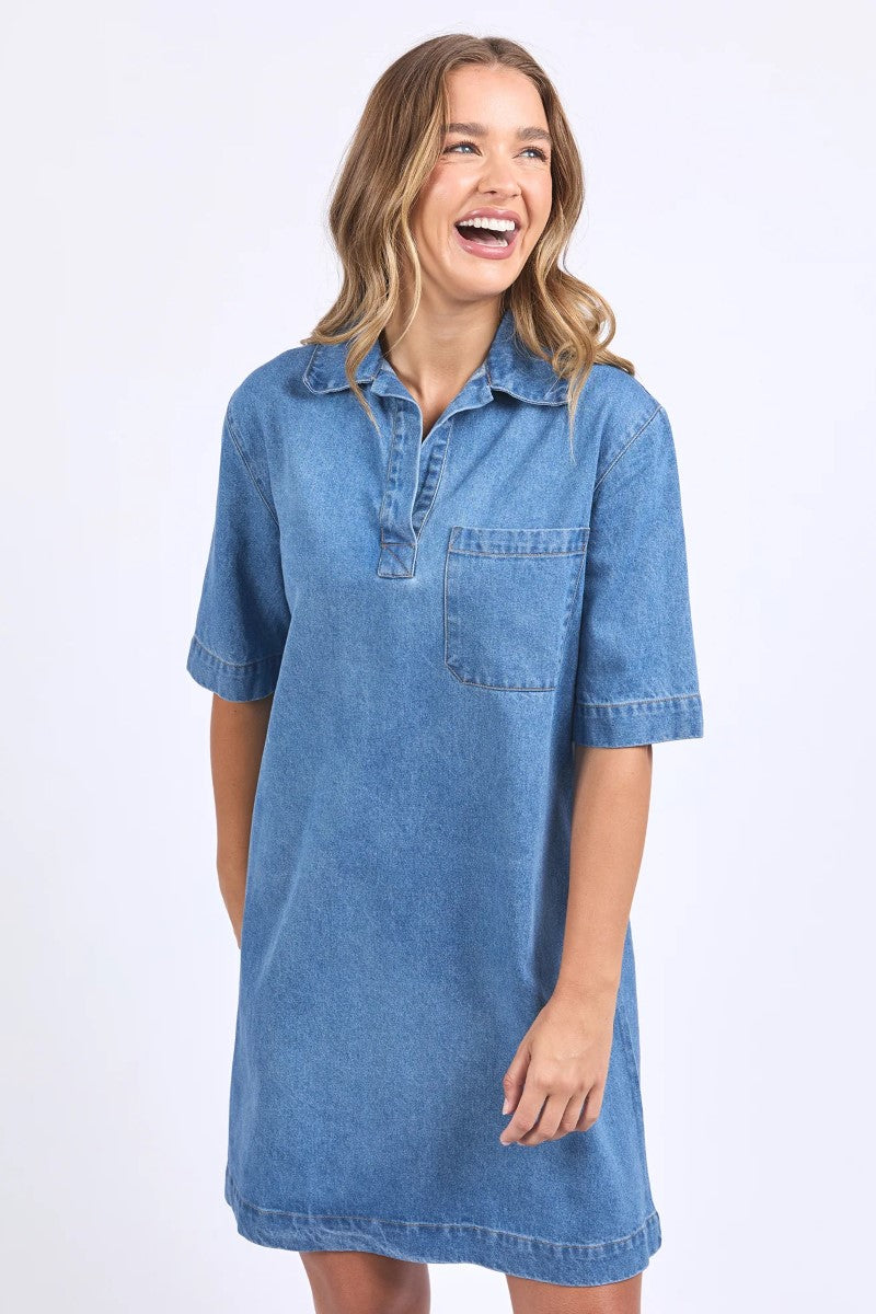 Woman wearing a blue denim dress on a white background