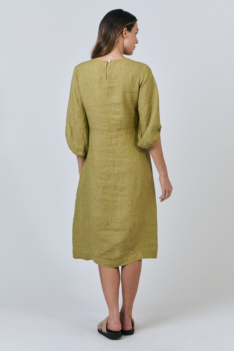 Woman wearing a green dress on a white background