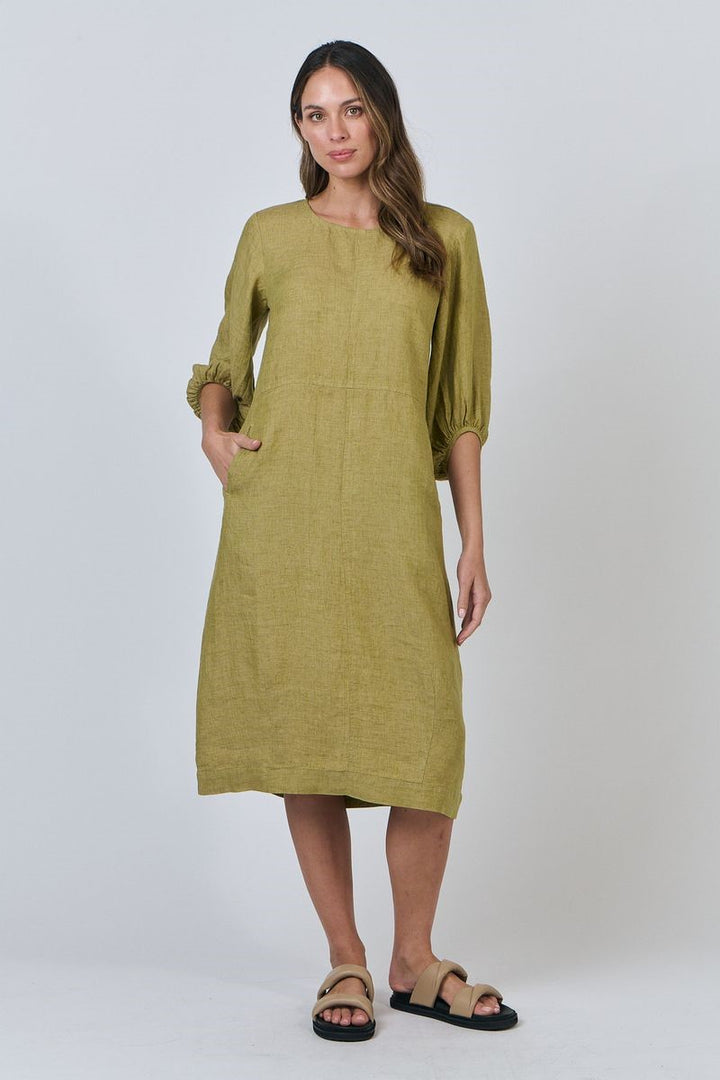 Woman wearing a green dress against a white background