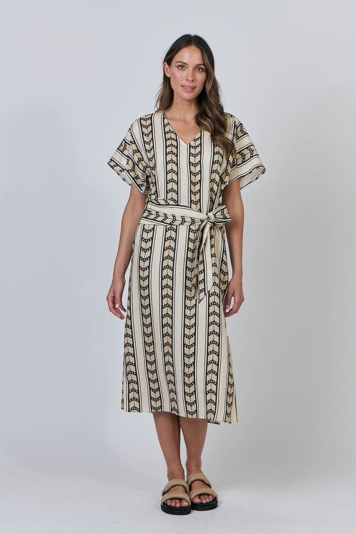 Woman wearing a patterned dress on a white background