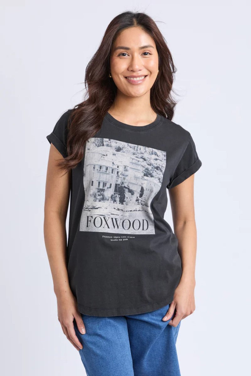 Woman wearing a black t-shirt with a graphic design and text on a white background