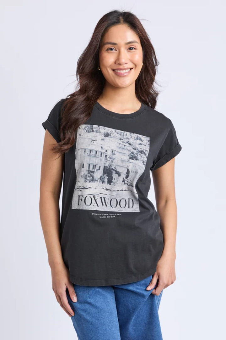 Woman wearing a black t-shirt with a graphic design and text on a white background