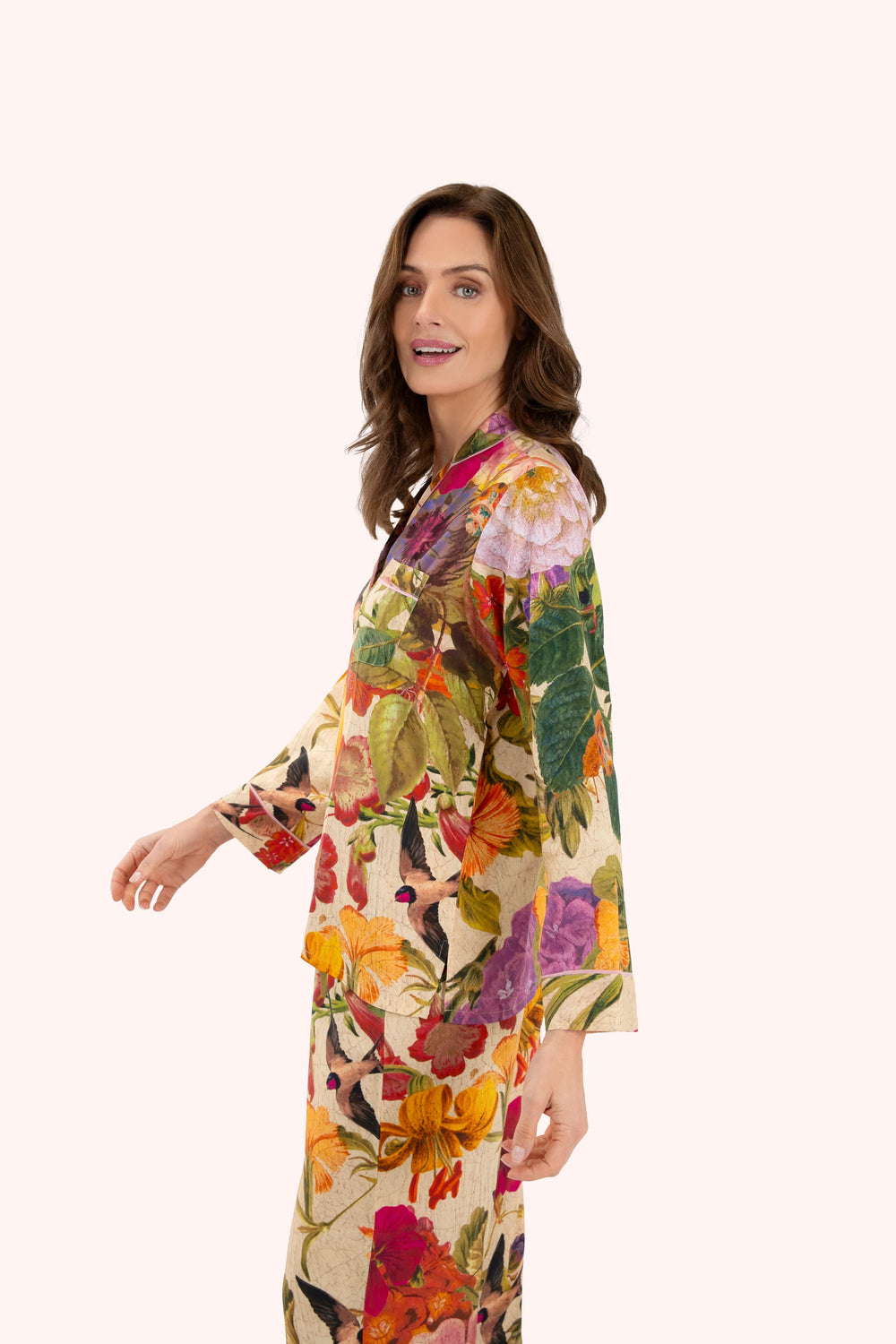 Woman wearing a colorful floral dress on a white background