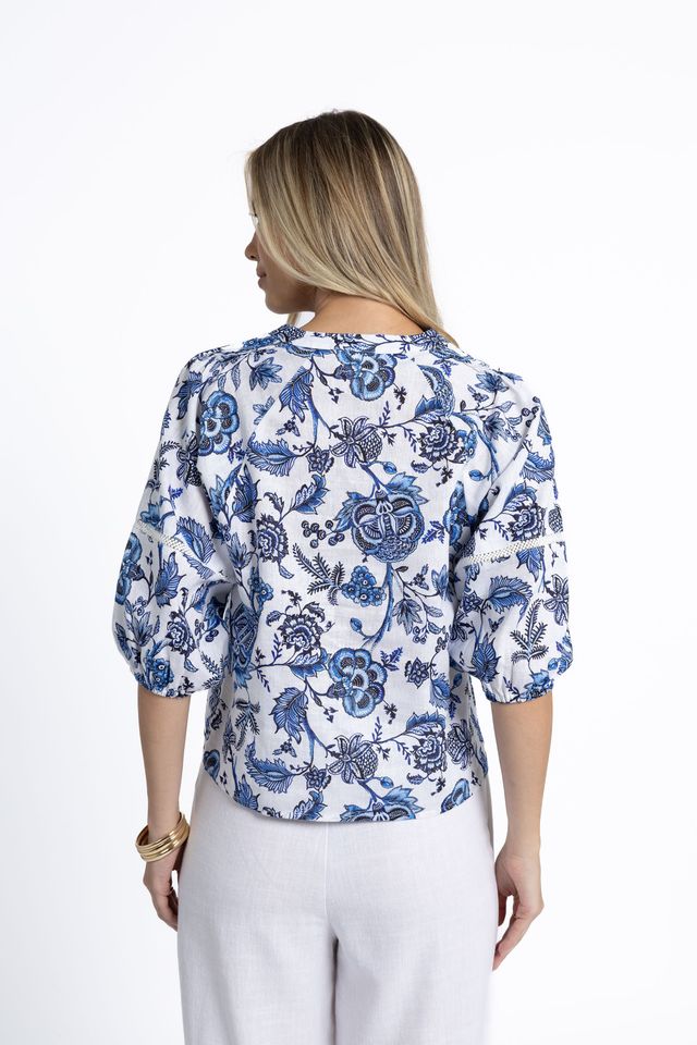 Woman wearing a blue floral blouse on a white background