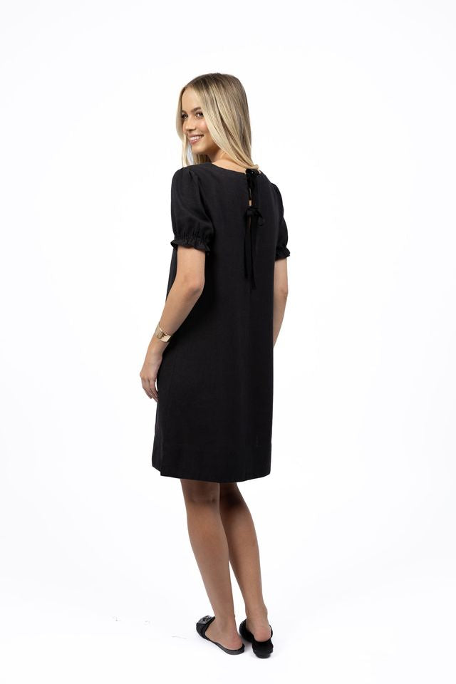 Woman wearing a black dress on a white background