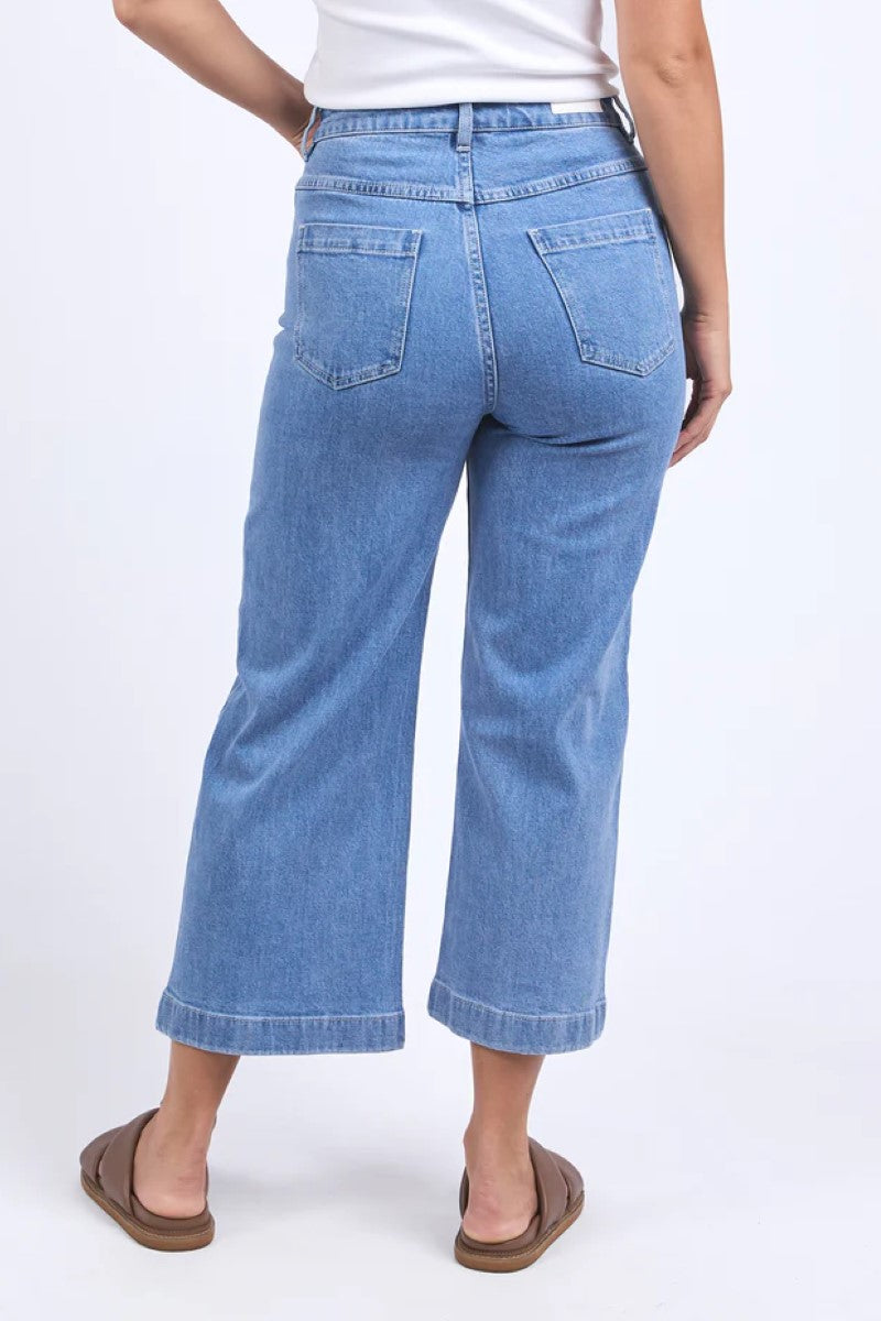 Person wearing blue jeans on a white background