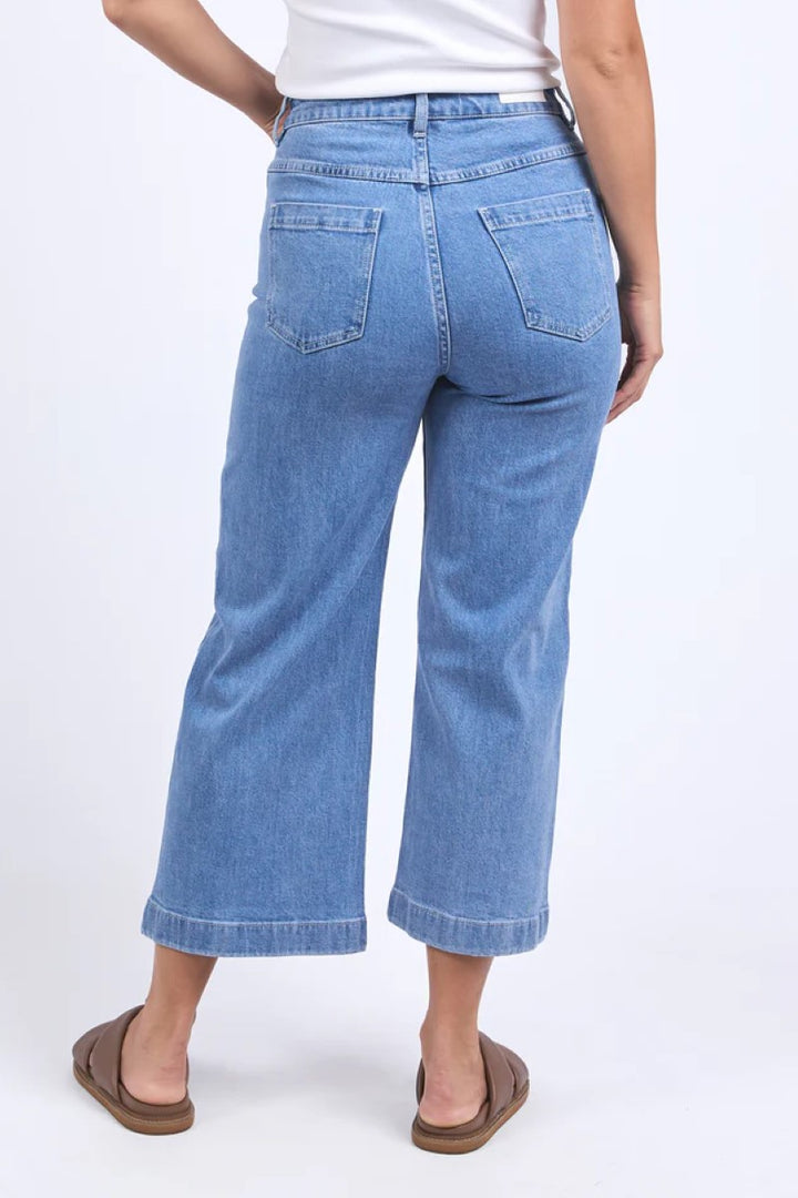 Person wearing blue jeans on a white background