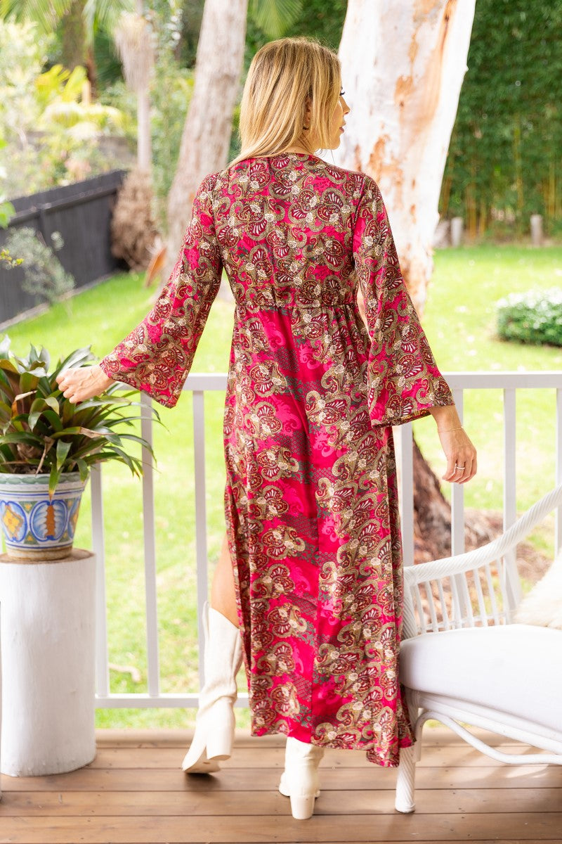 Back view of the Sofia Flare Sleeve Dress by Ivy Vibe, showcasing its elegant flare sleeves, fitted waistline, and flowing skirt with a clean, minimal back design.