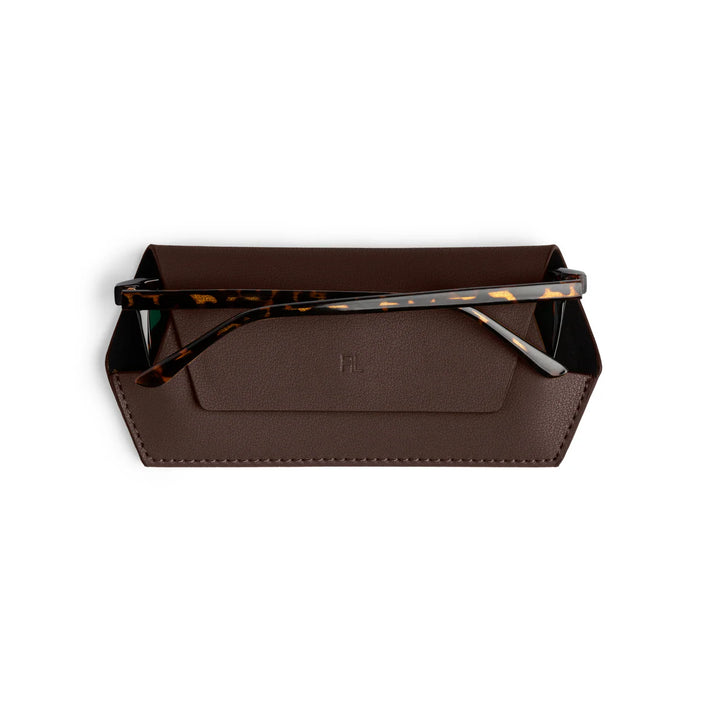 Brown leather tray with tortoiseshell sunglasses on a white background