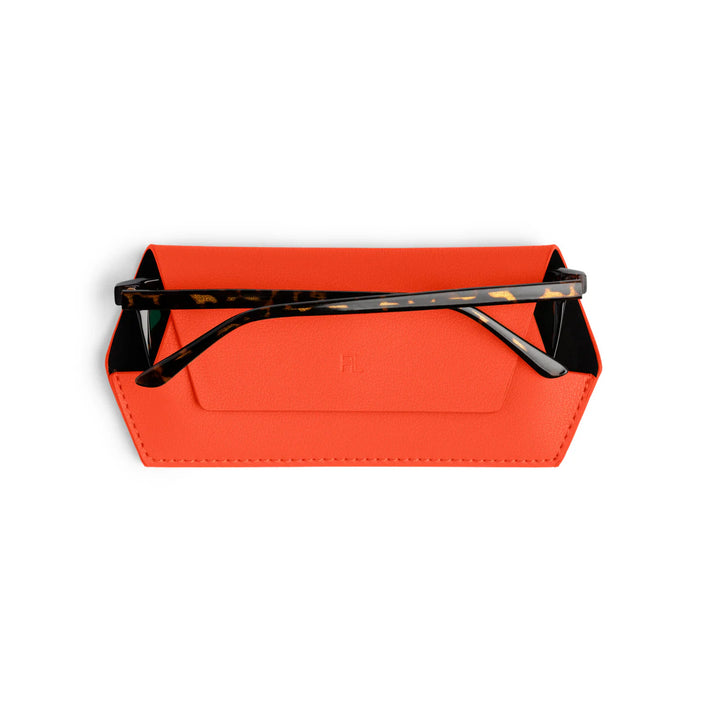 Orange sunglasses case with black sunglasses on a white background