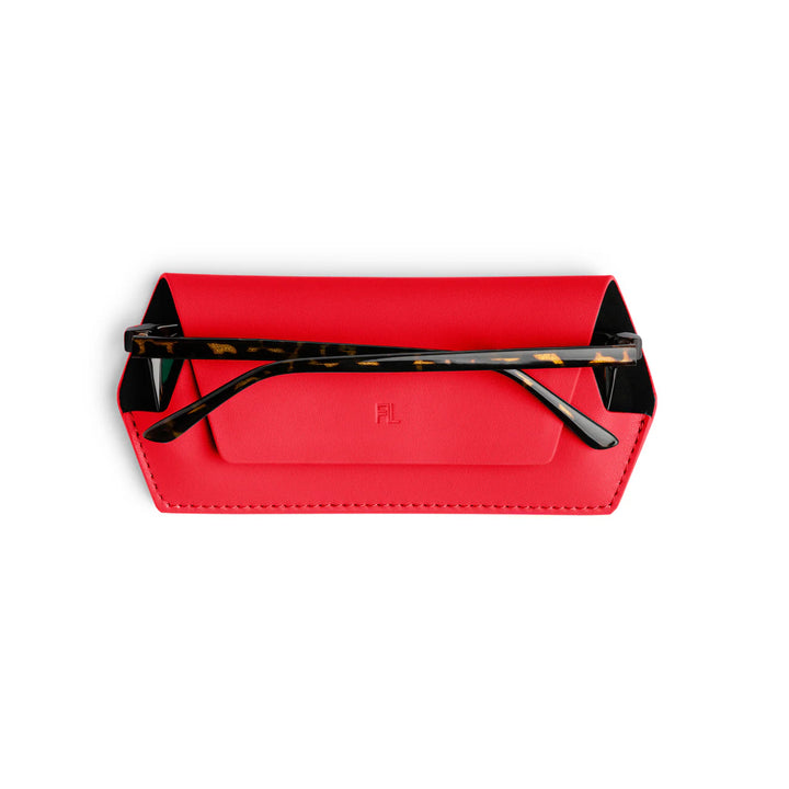 Red glasses case with tortoiseshell frame on a white background