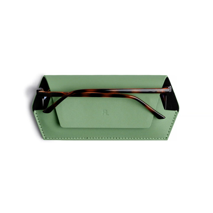 Green glasses case with tortoiseshell frame on a white background