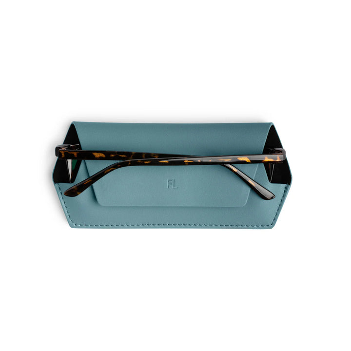 Blue glasses case with tortoiseshell frame on a white background