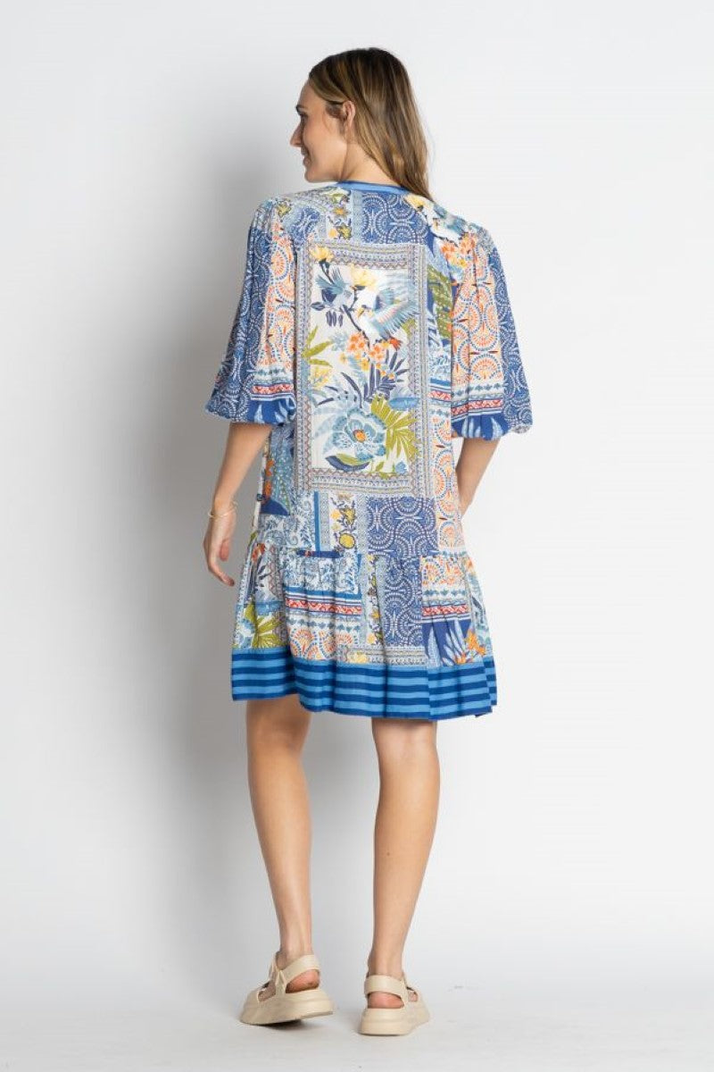 Woman wearing a colorful patterned dress on a white background