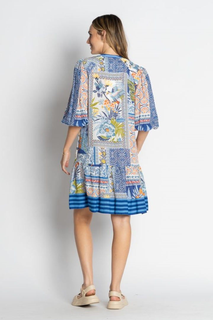 Woman wearing a colorful patterned dress on a white background